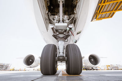 Low angle view of airplane against sky in city