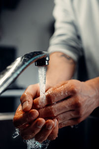 Close-up of person hand holding water