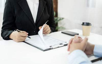 Midsection of businessman working at office