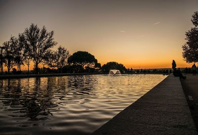 Scenic view of lake against sky at sunset