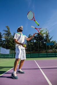 Man playing tennis at court