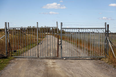 Fence on field against sky