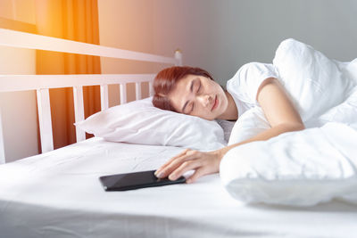 Young woman sleeping on bed at home