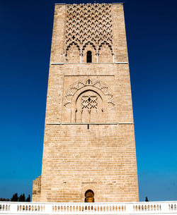 Low angle view of bell tower against blue sky