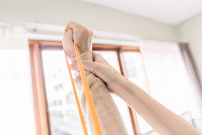 Cropped hand of woman holding book