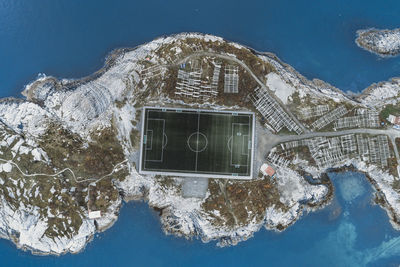 Soccer field on the cliffs of henningsvær by the sea