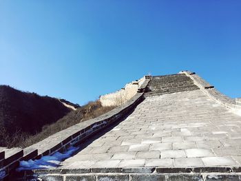 Low angle view of built structure against clear blue sky