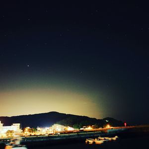 Scenic view of lake against sky at night