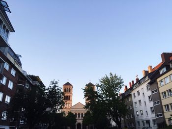 Low angle view of buildings against clear blue sky