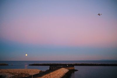 Scenic view of sea against clear sky during sunset