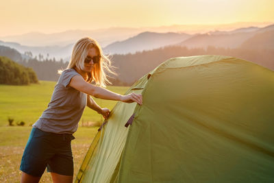 Rear view of woman sitting on tent