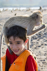 Portrait of smiling boy standing on beach