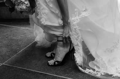 Low section of bride adjusting heels