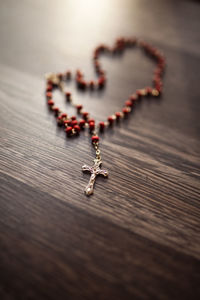 High angle view of rosary beads on table