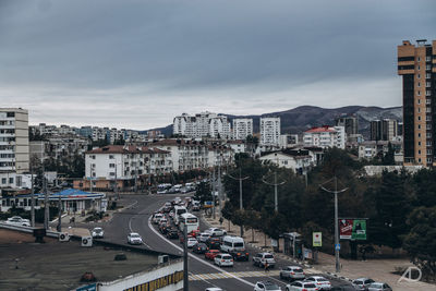 High angle view of city street and buildings against sky