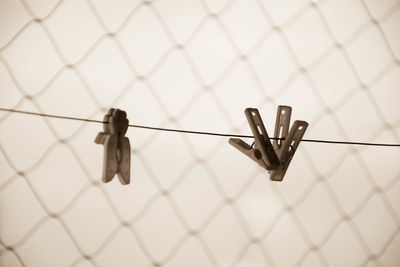 Close-up of clothespins on metal fence