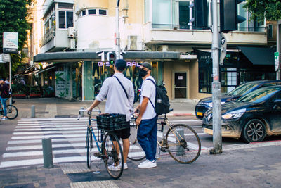 Man riding bicycle on city street