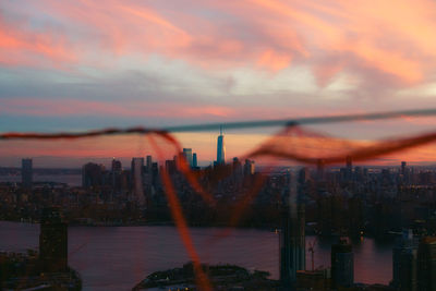 View of buildings against cloudy sky during sunset