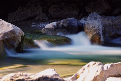 Scenic view of river flowing through rocks