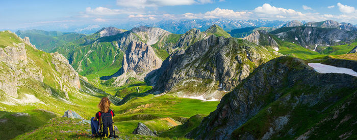 Rear view of woman with mountains in background