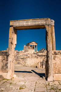 Old ruin building against blue sky