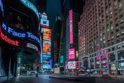 Low angle view of tall modern buildings at night