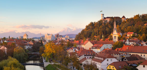 Town by buildings in city against sky