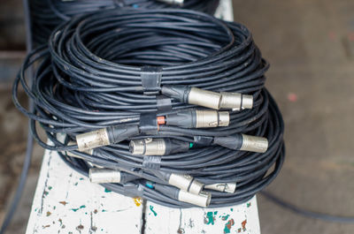 Stack of black cables on table