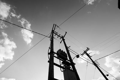 Low angle view of electricity pylon against sky