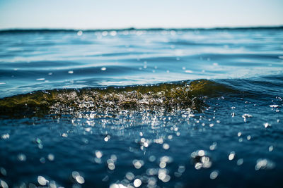 Scenic view of wave on sea against sky