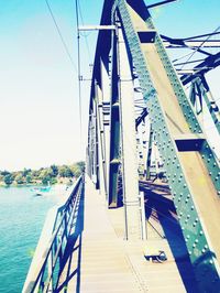 Low angle view of bridge over sea against clear sky