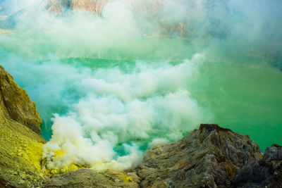 High angle view of smoke at volcanic crater