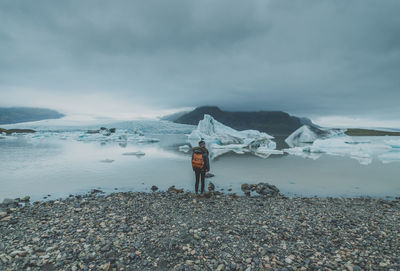 Man standing on beach against sky