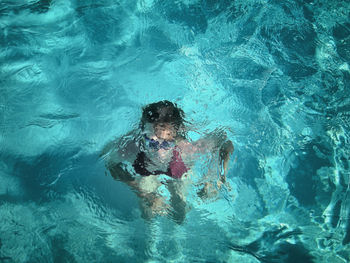 High angle view of girl swimming in pool