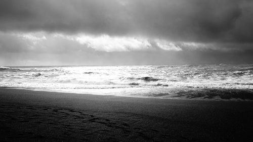 Scenic view of sea against cloudy sky