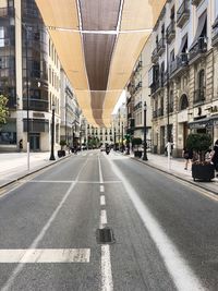 Surface level of street amidst buildings in city