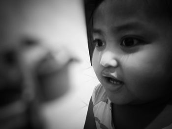 Close-up portrait of cute girl at home