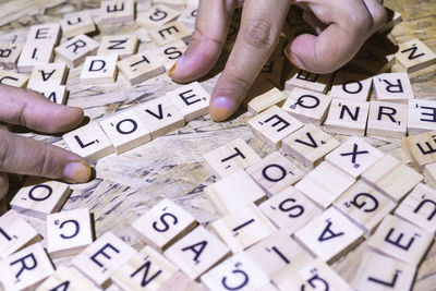 Close-up of man playing with text