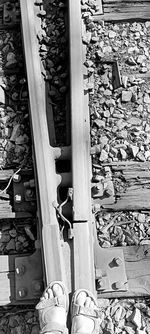 Low section of man standing on railroad track