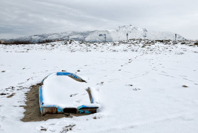 Snow covered land against sky