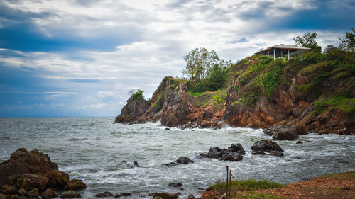 Rocks on beach against sky