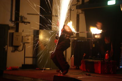 Musician performing fire stunt during concert