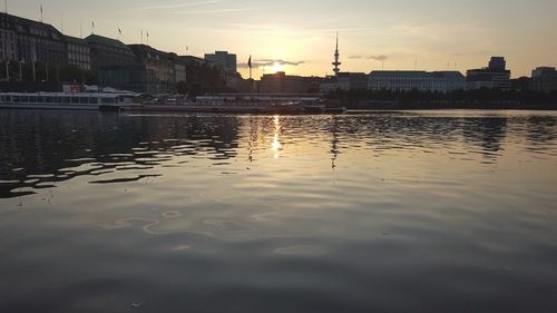 Scenic view of river against sky at sunset