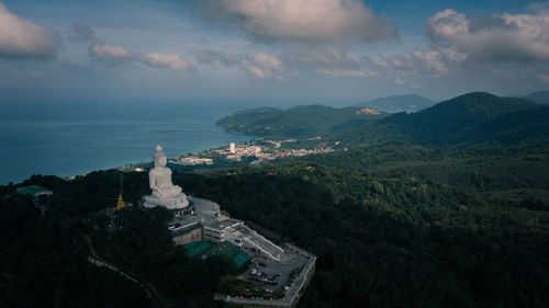 Big white buddha statue on top of mountain view point and landmark destination in phuket province 