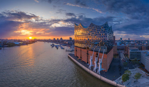 Panoramic view of elbe river and elbphilharmonie with sky during sunset