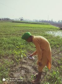 Side view of man working on field