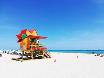 Lifeguard hut at beach against sky