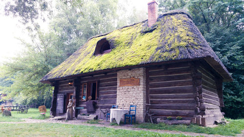 Old house amidst trees and building