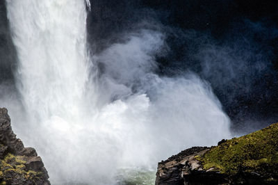 Scenic view of waterfall against sky