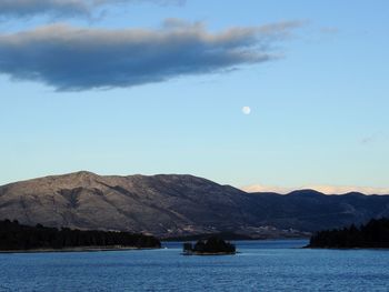 Scenic view of lake and mountains against sky